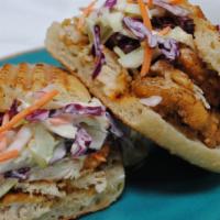 Fried Chicken Breast · Topped with spicy pineapple coleslaw on a sourdough torpedo roll.