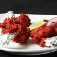  Chicken Lollipop · Chicken drumettes marinated in an egg and yogurt spiced mix and deep fried. Served with mint...