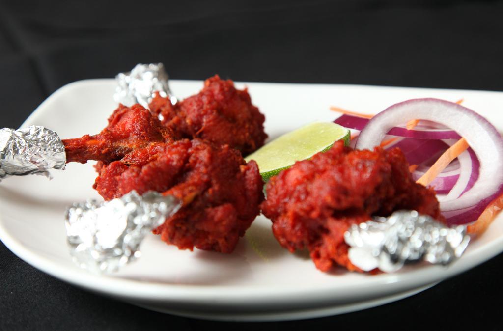  Chicken Lollipop · Chicken drumettes marinated in an egg and yogurt spiced mix and deep fried. Served with mint chutney.
