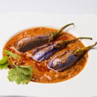 Bagara Baingan · Whole eggplants stuffed with a blend of peanut paste and spices and cooked in a tangy brown ...