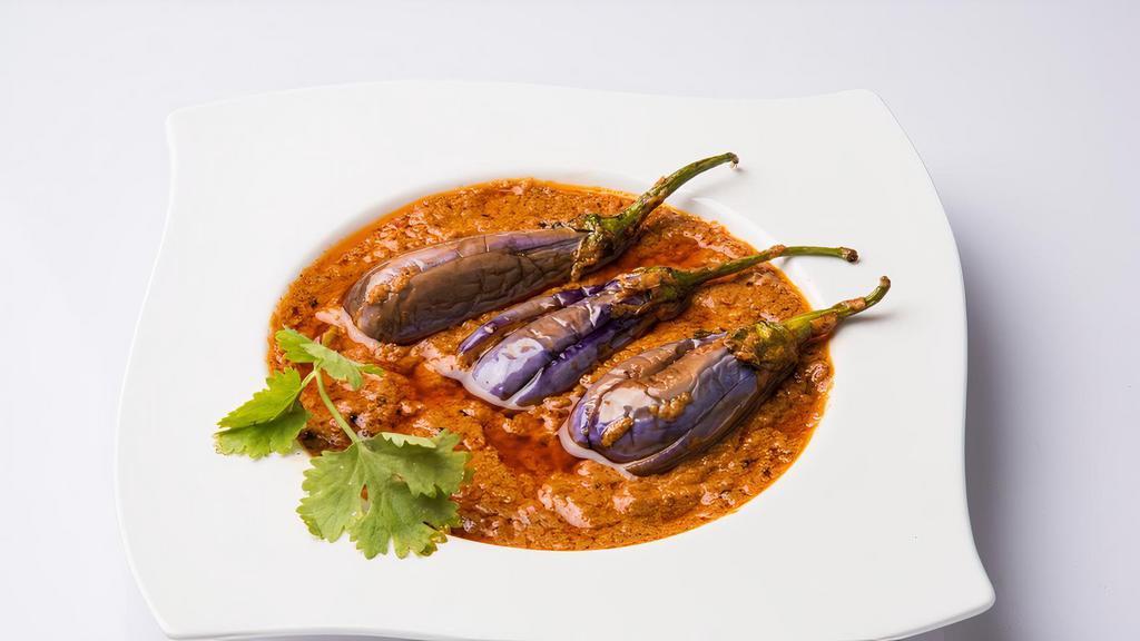Bagara Baingan · Whole eggplants stuffed with a blend of peanut paste and spices and cooked in a tangy brown sauce.