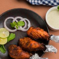 Tangre Kabab · Three pieces. Chicken drumsticks char-roasted in the tandoor and served sizzling hot.