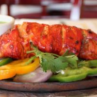 Tandoori Chicken Leg · Whole chicken leg marinated overnight with a mix of herbs and cooked in the tandoor.