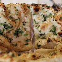Garlic Naan · Traditional naan topped with chopped garlic and cooked in the tandoor.