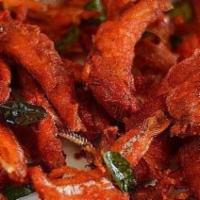 Fish 65 · Cubes of fish marinated in spicy masala & deep fried, garnished w/onion & lemon wedges.