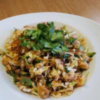 Burmese Chicken Salad · Bite-sized fried chicken with sliced onions, roasted bean powder, fried garlic, cilantro, an...
