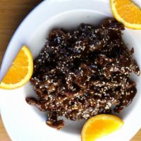 Sesame Beef · Strips of beef lightly fried in a sweet and tangy sauce, sliced and topped with sesame seeds.
