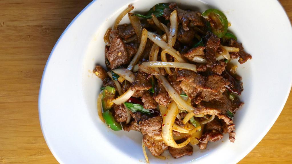 Basil Chili Beef · Strips of beef tossed with dried red chili flakes, fresh chili, onions, and finished with basil.