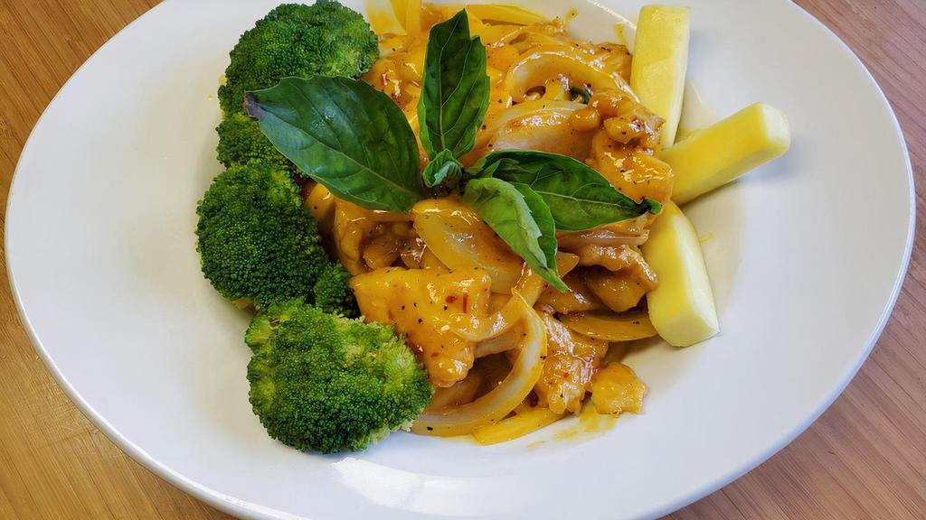 Mango Catfish · Catfish fillet tossed in a wok with basil, onions, and mango puree. Served with a side of fresh mango.