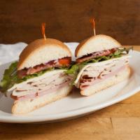 The Players Club Sandwich · Turkey, ham and provolone with lettuce, tomato, onions, mayo and dijon on telera.