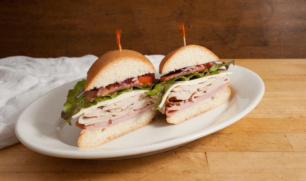 The Players Club Sandwich · Turkey, ham and provolone with lettuce, tomato, onions, mayo and dijon on telera.