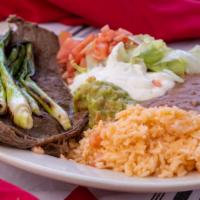 Carne Asada Grilled Steak Platillo · With rice, beans, lettuce, tomatoes, guacamole, sour cream and tortillas.