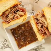 'Prime' (Prime Rib) · Prime Rib Dip sandwich is served on butter toasted bun with Au Jus and homemade crispy thin ...