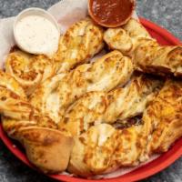 Garlic Parmesan Twists (6 Pieces) · Our famous Garlic Parmesan Twists. Rolled fresh daily and baked to perfection with fresh gar...