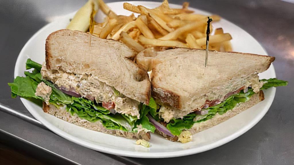 Albacore Tuna Salad Sandwich · Tuna Salad, Lettuce, Tomato, Red Onions, on Country Bread with Mayo.  Served with French Fries and a Pickle Wedge.