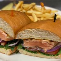 Grilled Salmon Sandwich · Arugula, Red Onions, Tomatoes & Lemon Dill Aioli on Brioche Bun

Served with French Fries an...