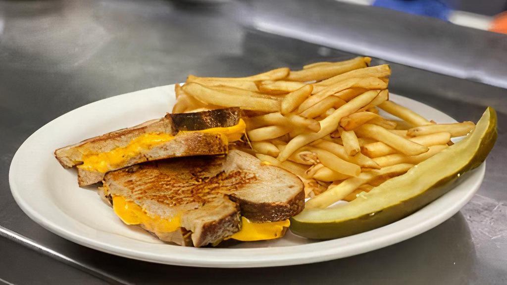 Grilled Cheese · American Cheese on Grilled Country Bread Served with French Fries and Pickle Wedge.