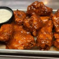 Chicken Wings · 12 Pieces with Choice of Classic Buffalo Sauce or Mango Habanero with Ranch Dressing
