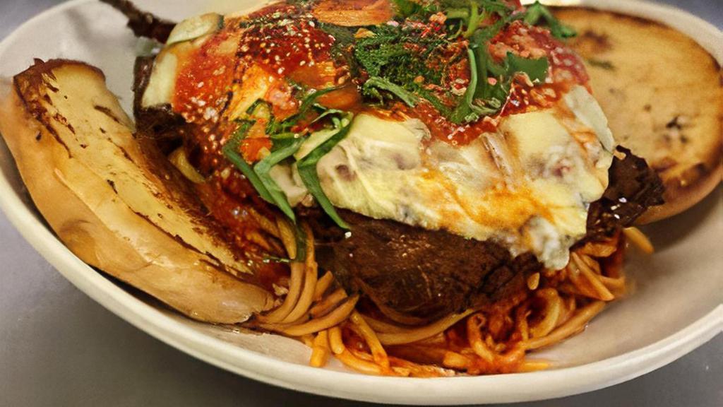 Chicken Parmigiana · Breaded Chicken Breast with Melted Mozzarella Served Over Spaghettini with Marinara Sauce