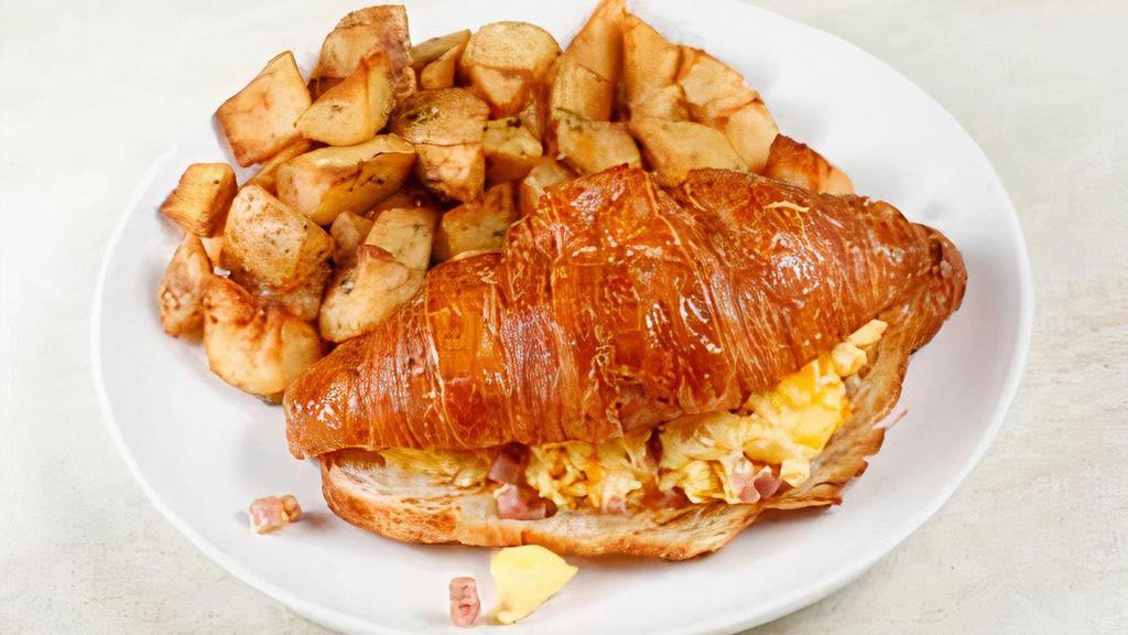 Croissant Sandwich · Two Eggs Scrambled with Smoked Pit Ham & Swiss Cheese in a Warm Croissant 

Served with Rosemary Garlic Potatoes