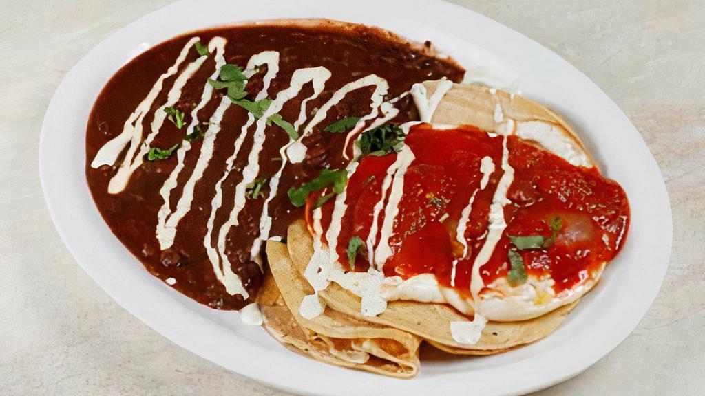 Huevos Rancheros · Two Eggs Over Easy, Pepper Jack Cheese & Corn Tortillas, Topped With Our Spicy Ranchero Sauce, Served With Black Bean Chili & Jalapeño Sour Cream