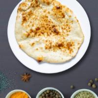 Butter Naan · Oven lovin' with freshly baked bread in a clay oven garnished with butter.
