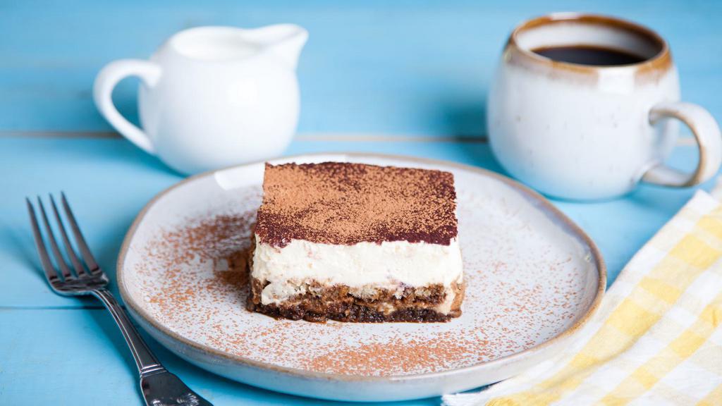 Tiramisu · Light dessert made with ladyfingers dipped in coffee, layers of fluffy mascarpone cheese and a hint of cocoa.