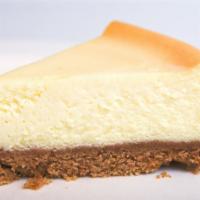 Ny Cheesecake · A smooth, creamy New York style cheesecake with a graham cracker crust.