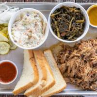 Pulled Pork Plate · Tender delicious melt in your mouth slow smoked pulled pork. Comes whit 2 sides, pickles, on...