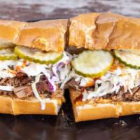 Smoked Brisket Sandwich · Slow smoked chopped bbq brisket, Texas BBQ sauce, melted pimento cheese, pickles, and cole s...