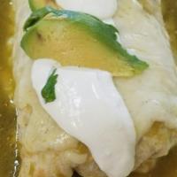 Wet Burrito · Burrito topped with enchilada sauce on top. Stuffed with Rice, beans,  onions, cilantro, sal...