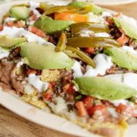 Super Nachos · Any meat, chips, refried beans, cheese, sour cream, avocado and jalapeños.