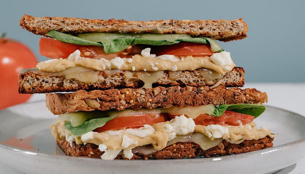 The Ultimate Grilled Cheese · Toasted Sprouted Bread, Cheddar Cheese, Feta, Provolone Cheese, Hummus, Tomato & Spinach