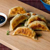 Pot Stickers · 6 pieces of crescent shaped potstickers with a crispy exterior and a juicy interior.