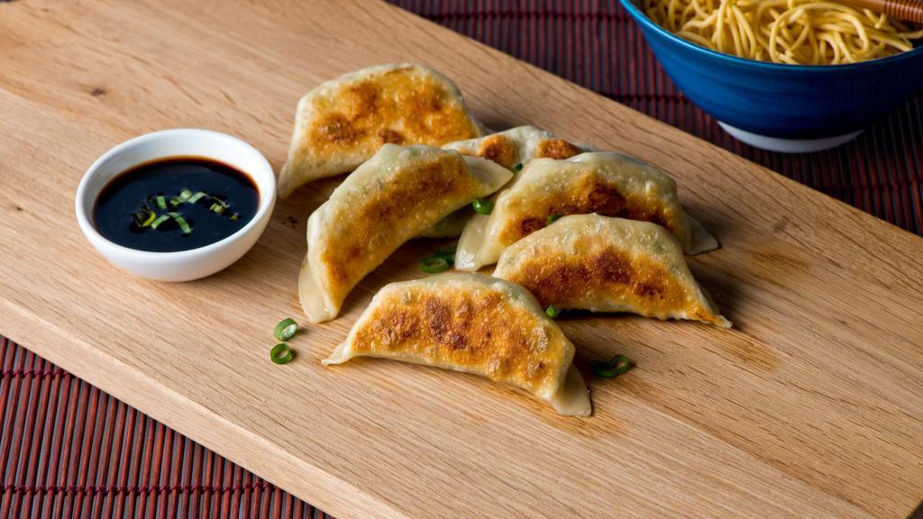 Pot Stickers · 6 pieces of crescent shaped potstickers with a crispy exterior and a juicy interior.
