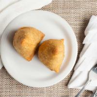 Samosa · Homemade crispy Indian pastry stuffed with spiced peas and potatoes.