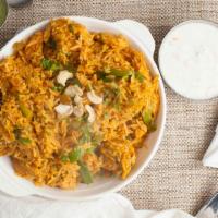 Chicken Biryani · Boneless spiced chicken cooked with basmati rice, onions, bell pepper, and nuts.