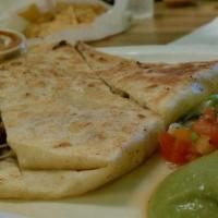 Super Quesadilla · Choice of meat inside, side of lettuce, sour cream and guacamole