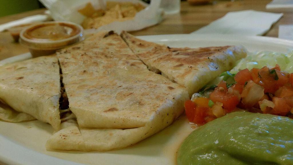 Super Quesadilla · Choice of meat inside, side of lettuce, sour cream and guacamole