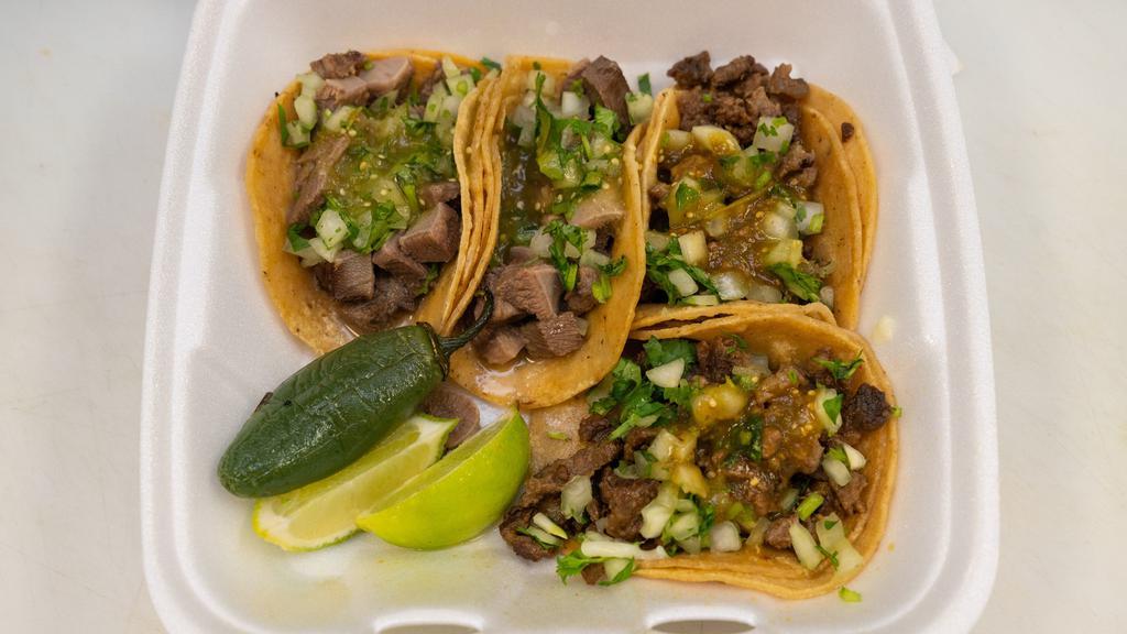 Carne Asada Plate · Includes rice, beans, pico de gallo, lettuce, guacamole, and corn tortillas.