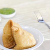 Samosa (2 pcs) · Deep-fried triangular pastry stuffed with mildly spiced potatoes and green peas. Served with...
