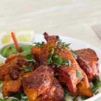 Tandoori Chicken Tikka · Boneless chicken breast marinated overnight in yogurt and homemade herbs and spices baked in...