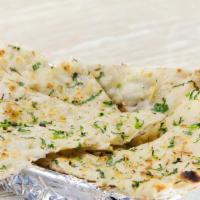 Garlic naan · Flatbread made with white flour with chopped garlic.