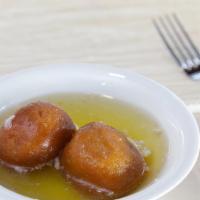 Gulab jamun · Dough balls consist mainly of milk solid in sugar syrup flavored with cardamom seeds.