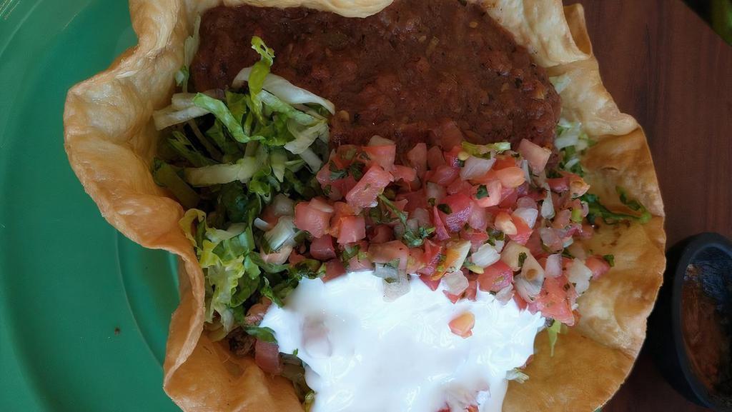 Taco Salad · A flour tortilla bowl Spanish rice, beans, lettuce,
tomatoes, salsa and crema fresca. Grilled
chicken, carne asada.