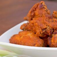 Buffalo Wings · Fried Wings Covered in Hot Sauce and Served with Blue Cheese Dressing and Celery Sticks