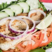 Grilled Basa Fish Salad · Grilled basa with mixed greens, tomatoes, cucumbers.