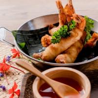 Prawn Rolls · Prawns wrapped in wonton skin, deep-fried, and served with sweet chili sauce.