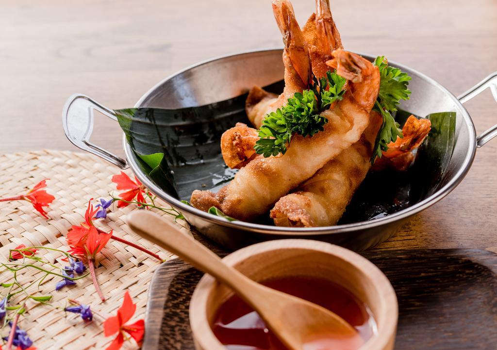 Prawn Rolls · Prawns wrapped in wonton skin, deep-fried, and served with sweet chili sauce.