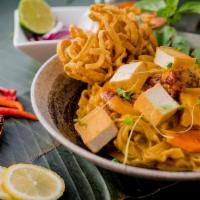 Curry Noodles (Khao Soi) · *Spicy. Egg noodles in a coconut milk enriched curry with Thai chili paste, garnished with r...